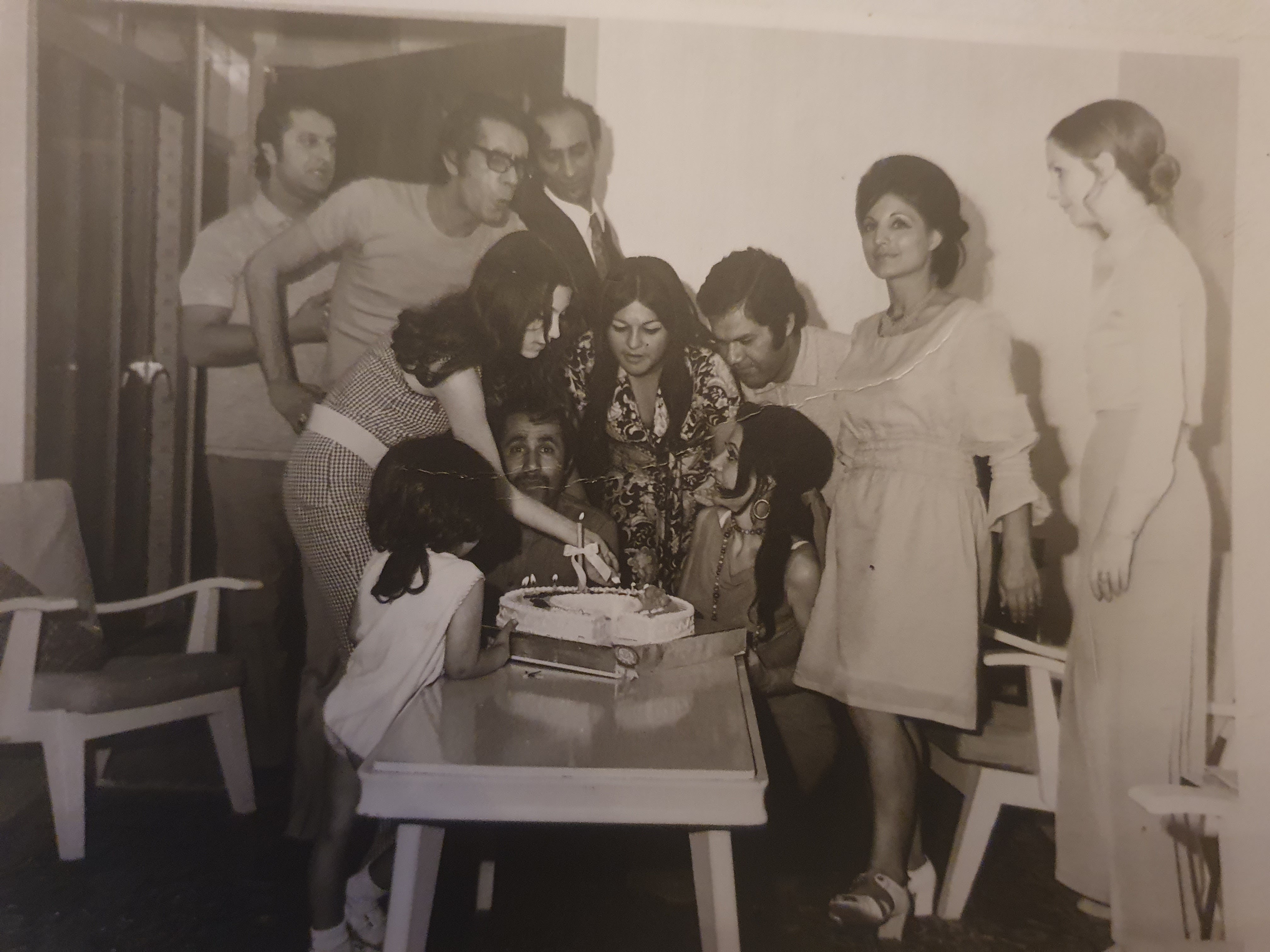 Gathered around a celebration cake