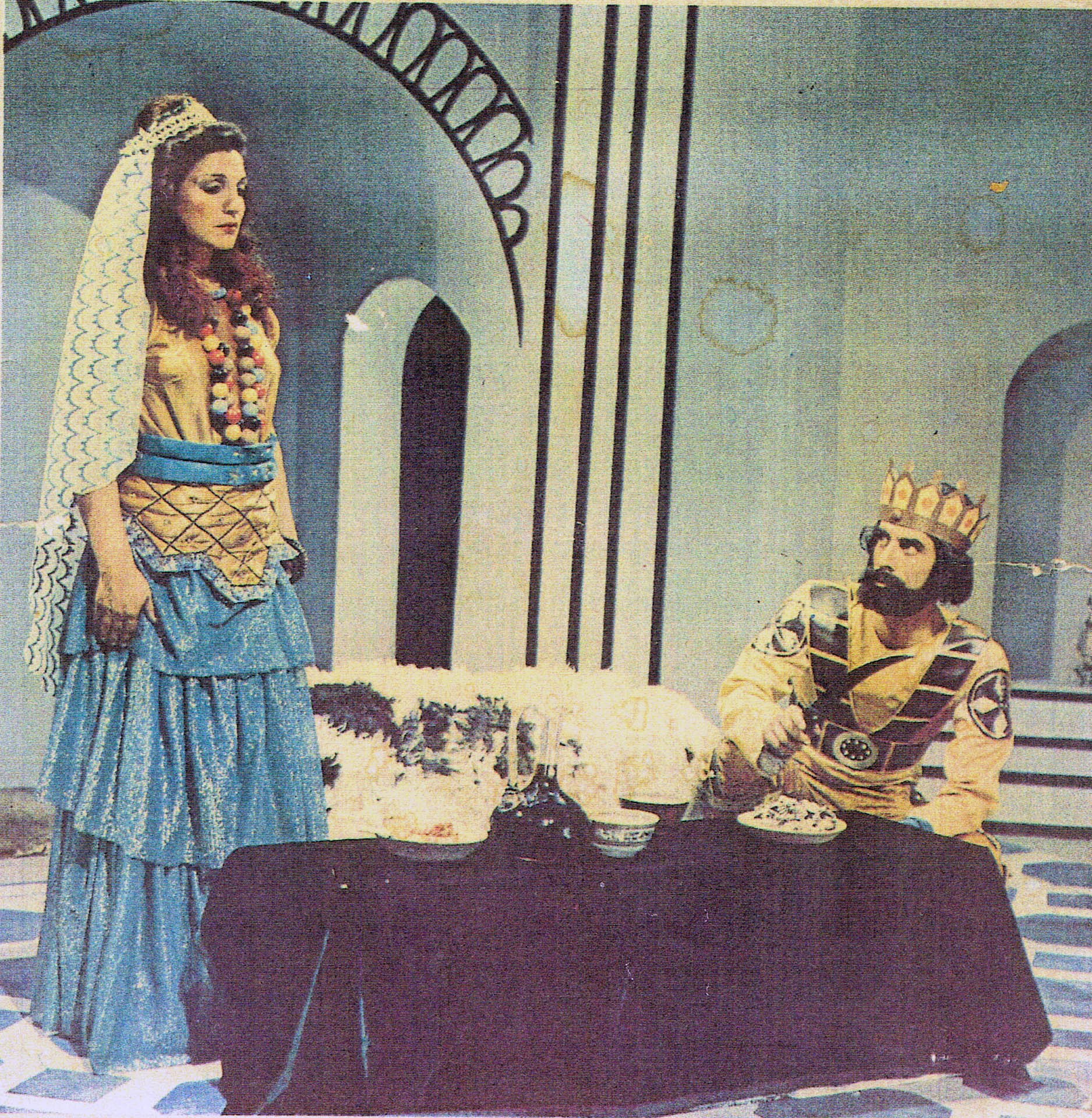 Two performers in theatrical costume on stage